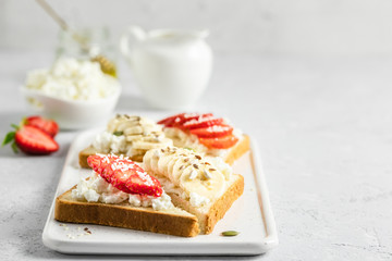 Strawberry banana cottage cheese crostini. Selective focus, copy space.