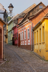 Medieval street with colourful houses in Sighisoara, Romania.