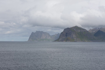 Beautiful view of the Norwegian fjords with turquoise water surrounded by cloudy sky, selective focus