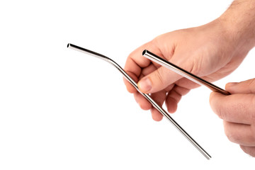Stainless steel metal straw in hand on a white isolated background. Reusable Metal Straws with Portable Case - Stainless Steel, Eco-Friendly Drinking Straw Set with  Cleaning Brushes. 