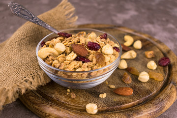 
Bowl with useful and nutritious granola on a wooden board.