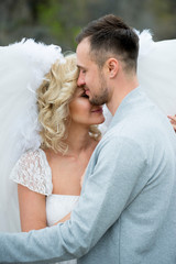 Fototapeta premium beautiful blonde girl in a white dress hugs a guy