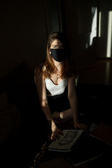 the sun's rays fall on a girl in a black mask
