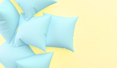 Blue pillows on a yellow background. The concept of a sleeping party. 3D rendering.