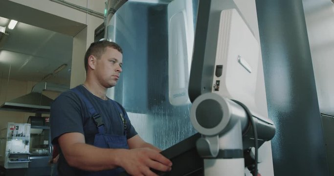 cnc screenshot. cnc machine management screen. laser cutting machine. man at cnc machine. Filmed on RED EPIC-W 4K camera.