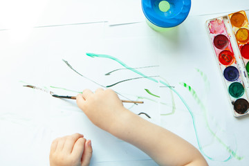 Creative boy, paints in his room. Educational games for preschool children