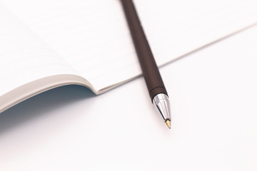 Notebook and fountain pen on a white background