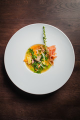 soup with vegetables and prosciutto