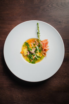 soup with vegetables and prosciutto