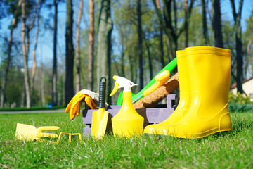 Gardening in the park. Garden tools on the natural green grass lawn. Spring garden works.