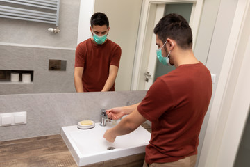 Fototapeta premium A man washes his hands thoroughly because of an epidemic.