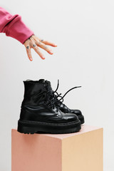 Hand reaching for boots