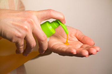 close-up girl squeezes soap and washes hands
