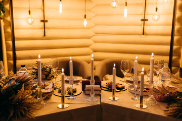 Burning candles on table indoors