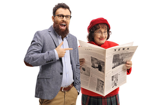 Bearded Man Laughing And Pointing At An Elderly Woman Reading A Newspaper