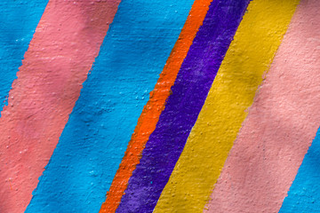 Background from multi-colored stripes painted with paint.