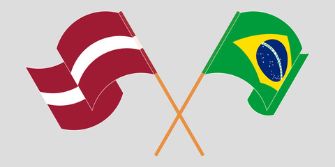 Crossed and waving flags of Latvia and Brazil