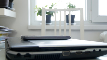 Image with a Laptop and a Mobile Phone on the Desk in the Office 
