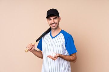 Young man over isolated background playing baseball