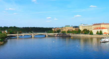 Fototapeta na wymiar View of the Vltava river with a boat in the summer. Prague. Czech Republic