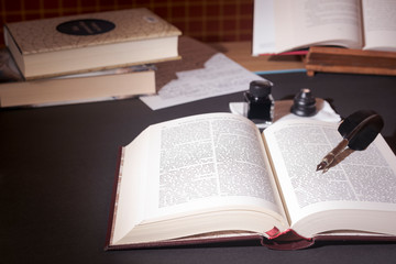 Old books, pen and ink on the table