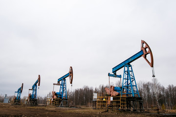 Fototapeta na wymiar Green Oil pump oil rig energy industrial machine for petroleum crude. oil crisis. Russia pumps oil pollution.