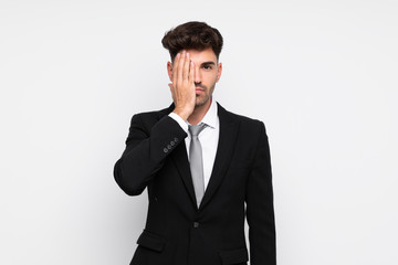 Young businessman over isolated white background covering a eye by hand