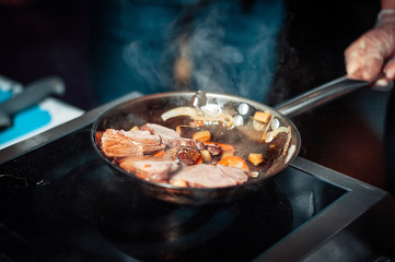 the meat is fried in a pan