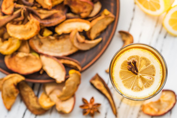 Dried fruits drink with lemon on a wooden background. Uzvar could be drunk cold or hot.