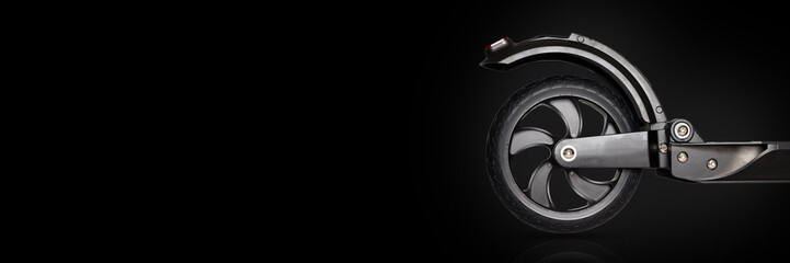 Obraz premium Electric black scooter on the black background