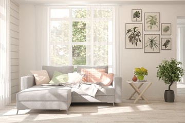White living room with sofa and summer landscape in window. Scandinavian interior design. 3D illustration