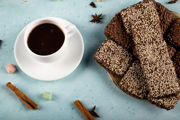 Bitter chocolate bars with anise aroma with a cup of tea, top view