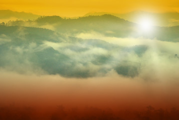 Sunrise among forests and mountains