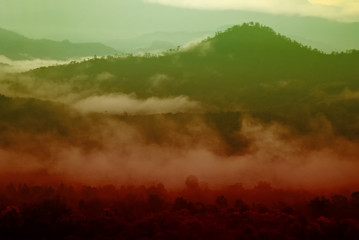 View landscape with silhouettes of mountains range with mist or covered by heavy fog