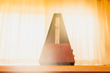 wooden metronome with warm light