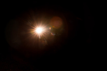 Abstract Natural Sun flare on the black background.