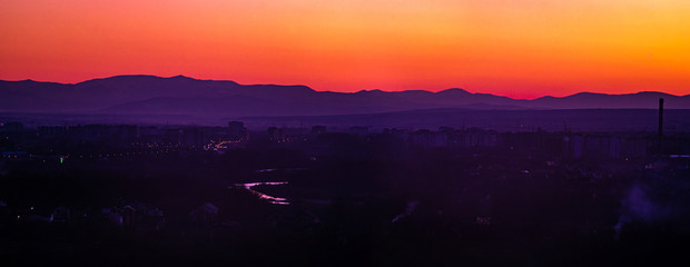 Sunset on the background of the city in spring