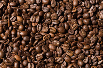 roasted coffee beans are on the table. coffee beans close-up top view