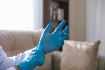 Doctor wearing sterile surgery gloves for stopping the spread of Covid-19, 2019-nCoV or Coronavirus.