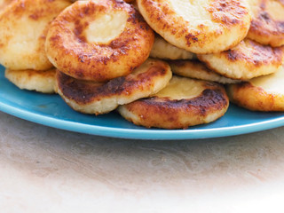 Cheesecakes are piled on a plate. Delicious cheesecakes with a Golden crust are piled on a plate