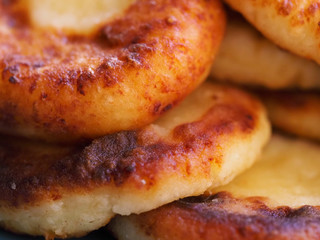 Cottage cheese pancakes are photographed close up as a background. Delicious cheesecake with a Golden crust photographed close-up