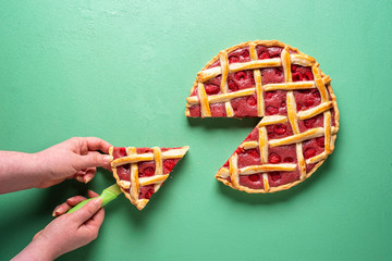 Grabbing slice of cake. Raspberry pie with lattice top