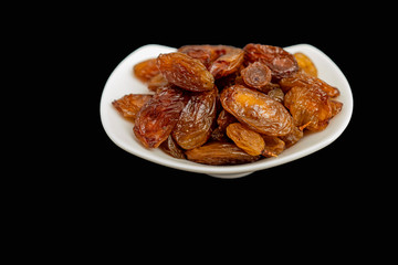 Black raisins on black background