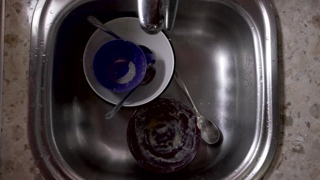 Stack dishes in the sink in the kitchen. Top view.