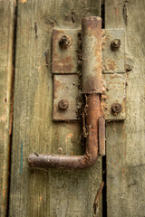 A closeup  of a metal old rusty lock on a wooden door