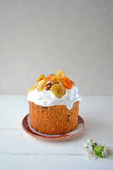 Traditional Easter cake with icing and dried fruit on top. Paska or kulich sponge cake.