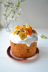 Traditional Easter cake with icing and dried fruit on top. Paska or kulich sponge cake.