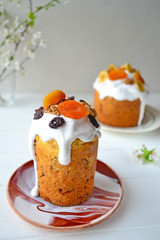 Traditional Easter cake with icing and dried fruit on top. Paska or kulich sponge cake.
