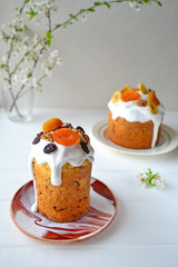 Traditional Easter cake with icing and dried fruit on top. Paska or kulich sponge cake.
