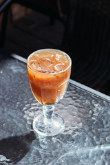 Orange iced coffee, summer cold drink in cafe on street, menu.